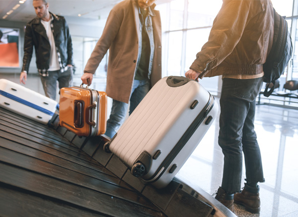 Travel Group Collecting Luggage